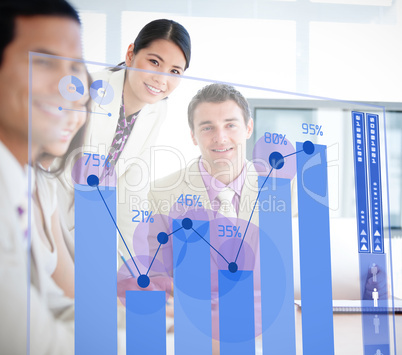 Smiling business workers looking at blue chart interface