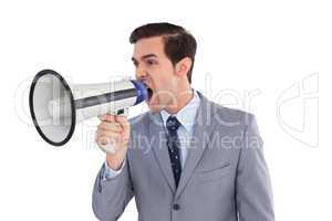 Businessman yelling into a megaphone