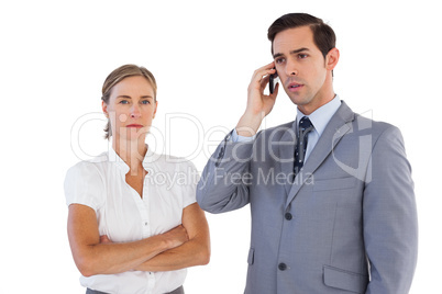 Businessman on the phone next to his colleague