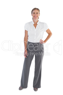 Smiling businesswoman standing with her hand on her hip