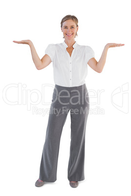 Smiling businesswoman presenting something with her two hands ra