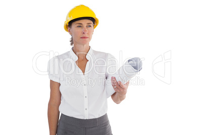 Serious female architect holding plans and hard hat