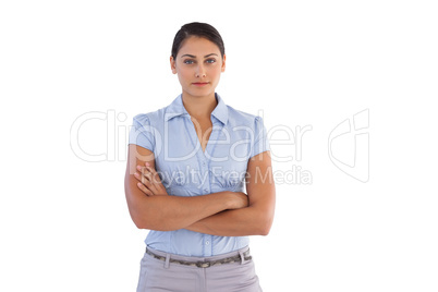 Young businesswoman standing alone with her arms crossed