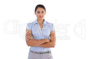 Young businesswoman standing alone with her arms crossed