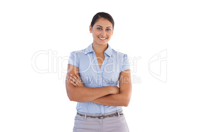 Smiling businesswoman standing alone with her arms crossed