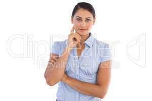 Businesswoman standing alone with her hand to her face