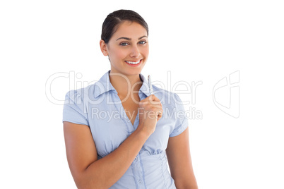 Thoughtful smiling businesswoman holding a pen