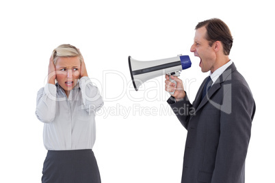 Businessman shouting at colleague with his bullhorn