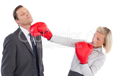 Businesswoman hitting colleague with boxing gloves