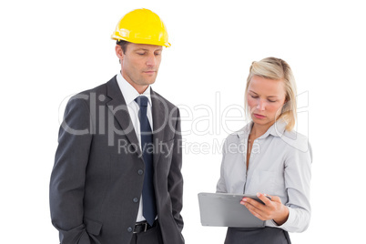 Two architects looking at clipboard