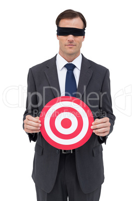 Blindfolded businessman holding a red target