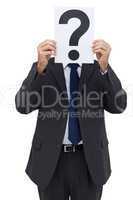 Businessman holding a question mark paper in front of his face