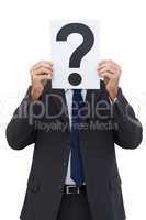 Businessman holding a question mark paper
