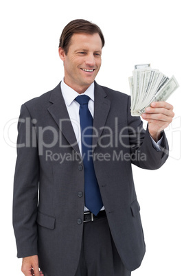 Smiling businessman holding bills