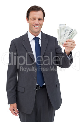 Smiling businessman holding dollar bills