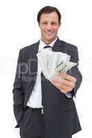 Smiling businessman holding cash