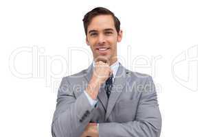 Smiling young businessman looking at the camera