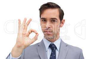 Serious businessman showing ok sign