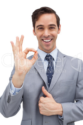 Cheerful businessman showing ok sign