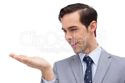 Businessman looking at his opened hand Businessman looking at his opened hand