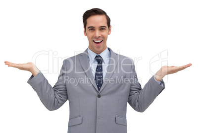 Smiling businessman presenting something with his hands