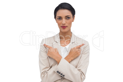 Charismatic businesswoman with her arms crossed and fingers poin