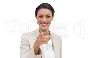 Smiling businesswoman pointing at camera