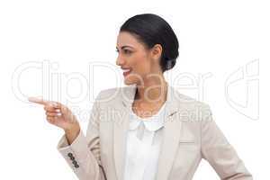 Profile view of a smiling businesswoman pointing