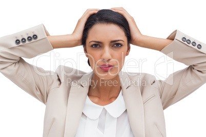 Stressed businesswoman holding her head between hands