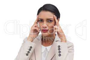 Young businesswoman putting her fingers on her temples