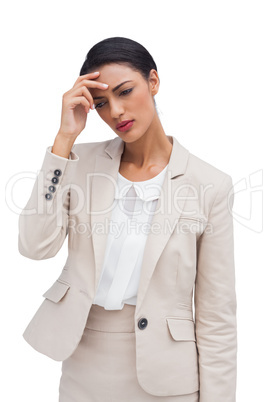 Worried businesswoman holding her head