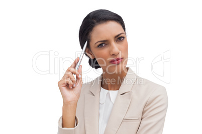 Thoughtful businesswoman holding a pen