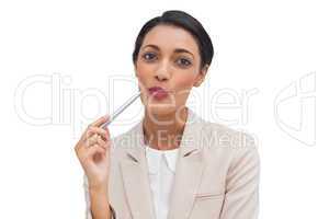 Cheerful businesswoman holding a pen