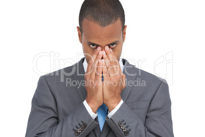 Young businessman holding his head between hands