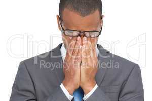 Businessman with glasses holding his head between hands