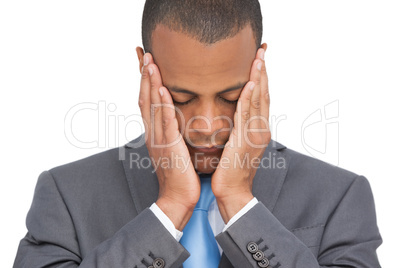 Stressed businessman holding her head between hands