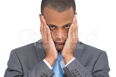 Stressed young businessman holding her head between hands