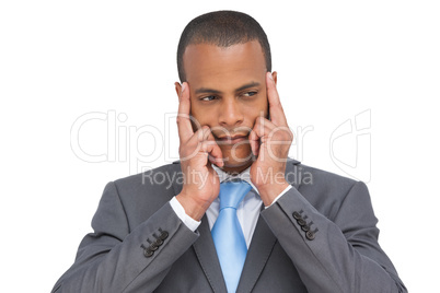 Young businessman putting his fingers on his temples