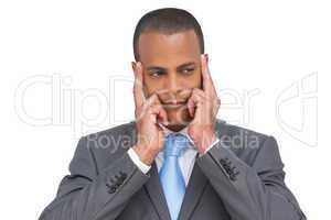 Young businessman putting his fingers on his temples