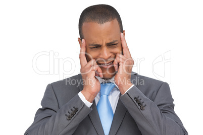 Stressed businessman putting his fingers on his temples
