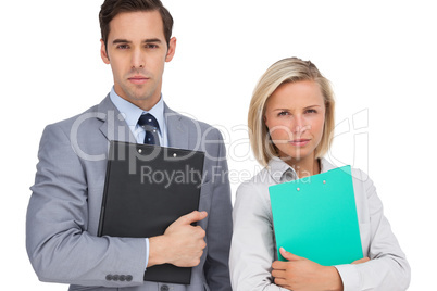 Serious business people standing together with folders