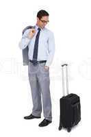 Smiling businessman looking at his suitcase