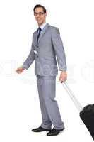 Smiling businessman walking with his suitcase