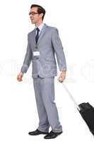 Smiling businessman walking with his suitcase