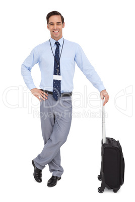 Handsome businessman standing with his suitcase