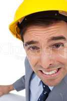 Close up of architect with hard hat grimacing while holding plan