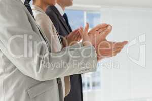 Business people applauding together