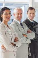 Three smiling business people standing together