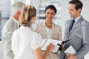 Smiling business people making an appointment