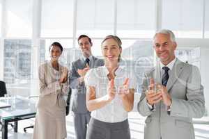 Group of business people applauding together